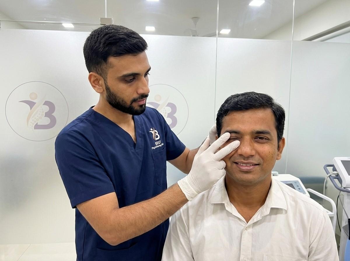 Physiotherapist Dr. Sagar performing manual facial massage and muscle stimulation on a male patient with Bell's Palsy.