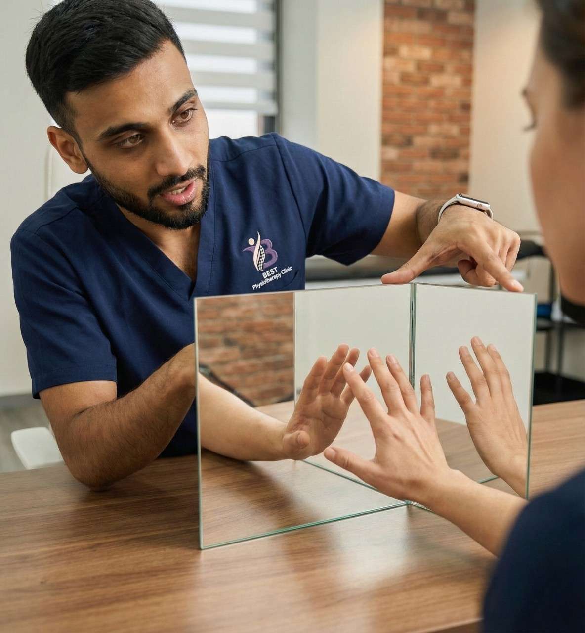 Physiotherapist demonstrating mirror therapy hand exercises to enhance motor control and sensory feedback.