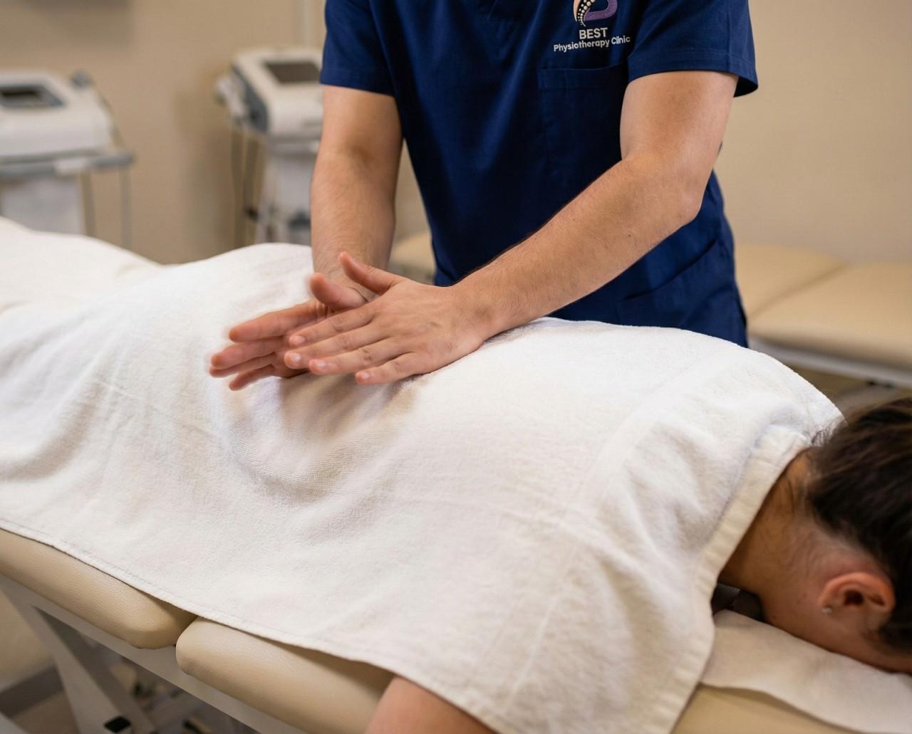 A physiotherapist performing chest percussion during postural drainage therapy to help remove respiratory secretions.