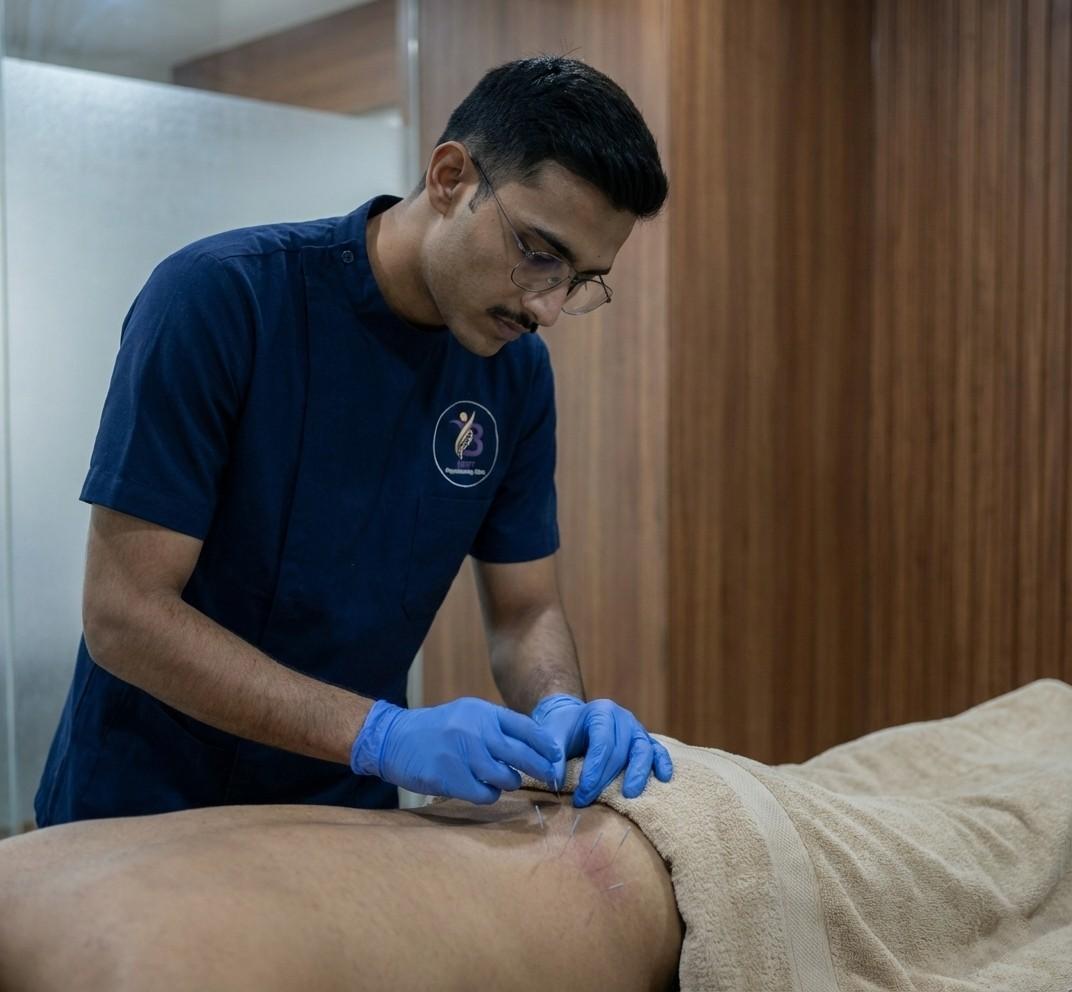 Physiotherapist performing dry needling or trigger point therapy on the gluteal muscles to treat piriformis syndrome and sciatica
