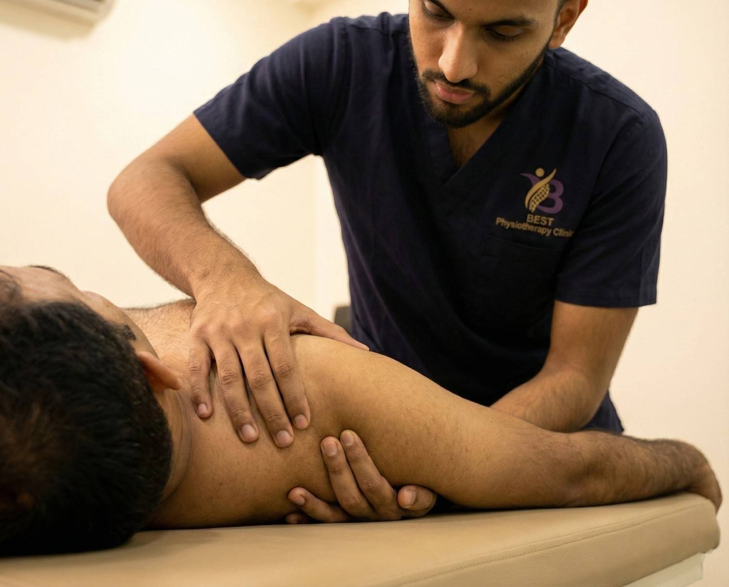 Physiotherapist performing hands-on joint mobilisation and soft tissue release techniques for chronic Shoulder Pain