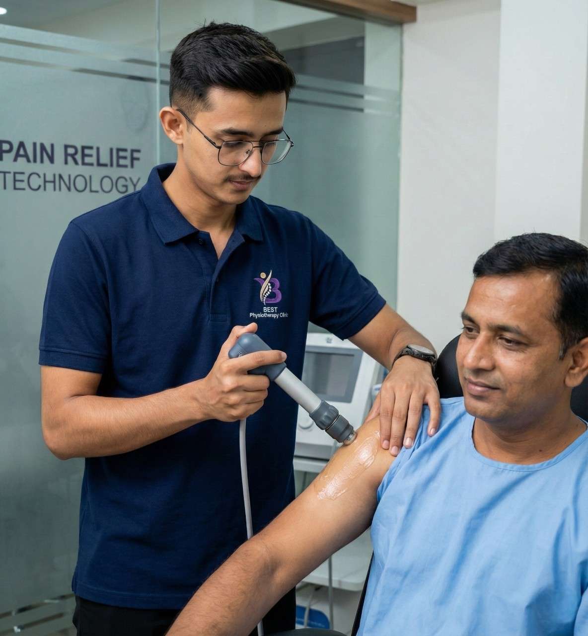 Physiotherapist using pain relief technology on a patient's shoulder or arm.