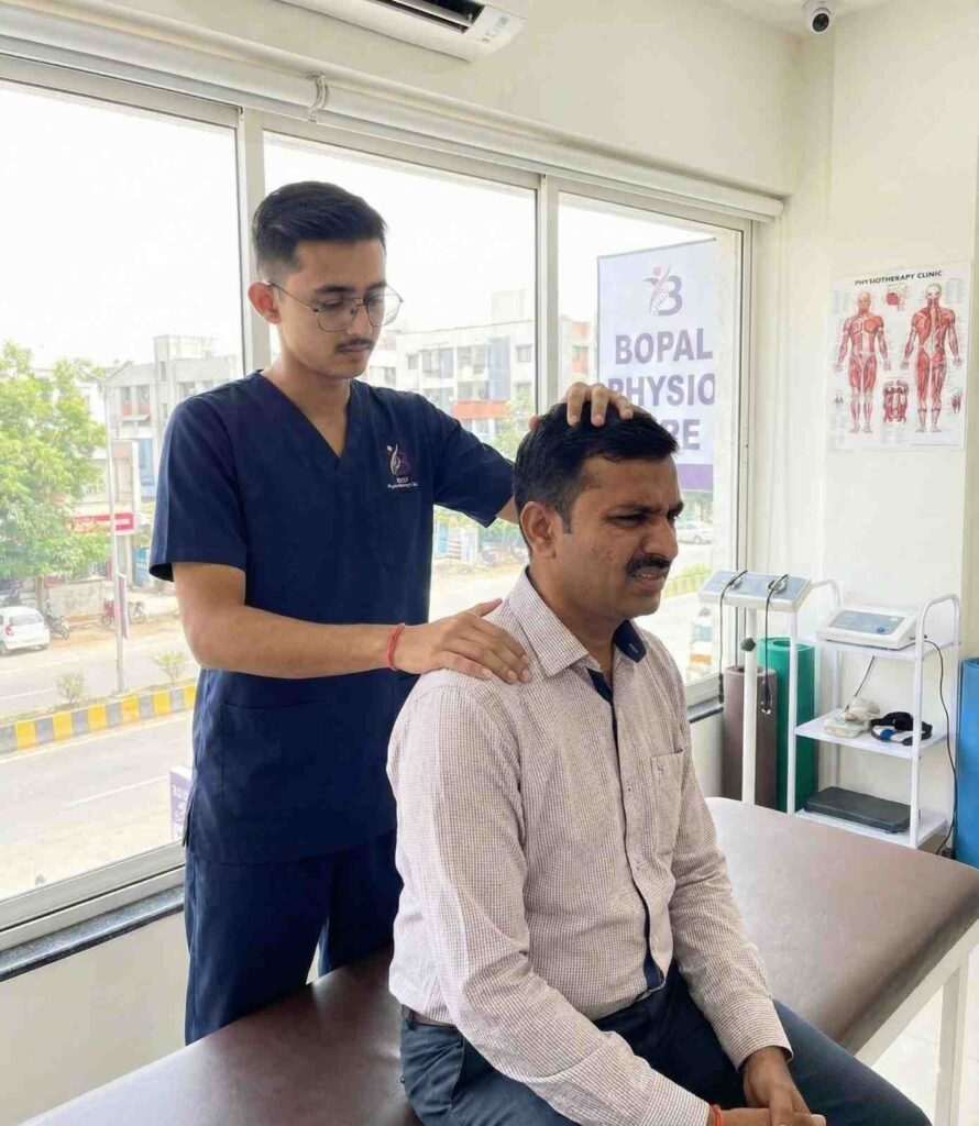 Dr. kanaiya physiotherapist helping desk worker with neck pain and posture correction in Best Physiotherapy Clinic in Bopal